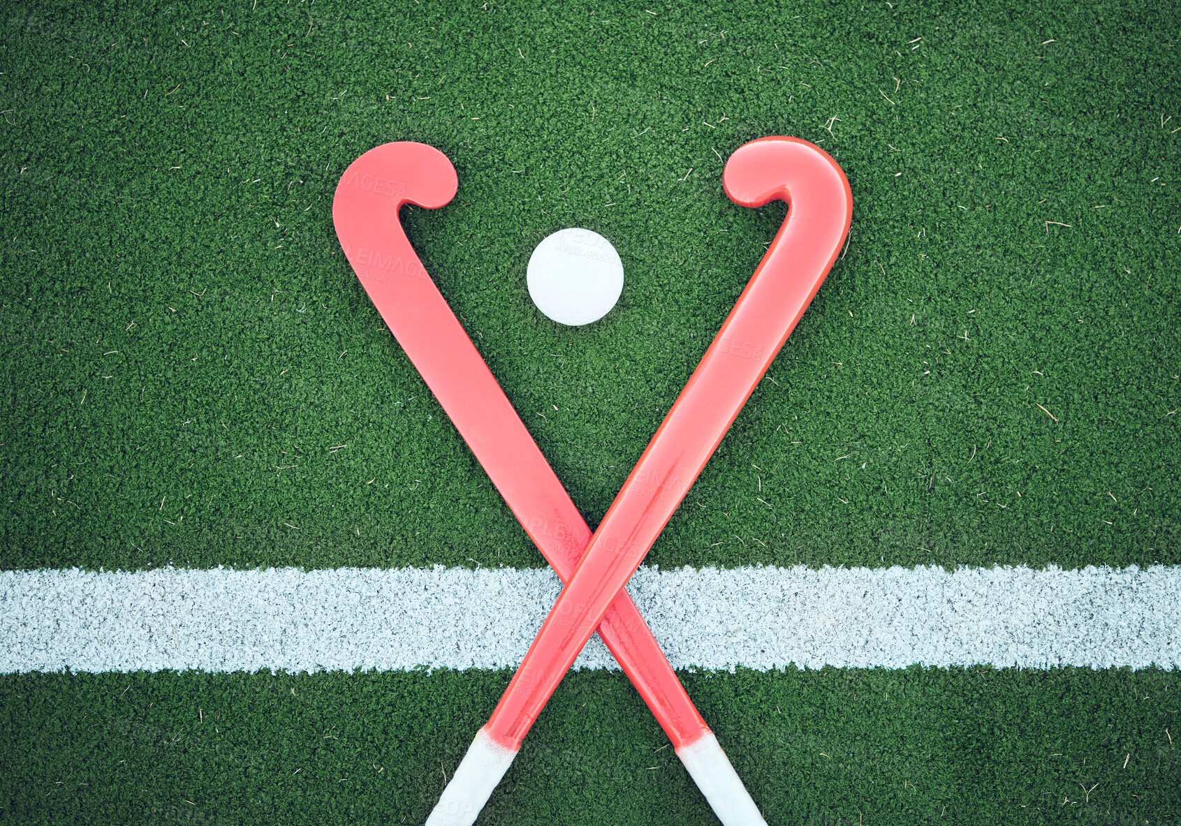 Buy stock photo Turf field, hockey stick or sports ball on the ground for fitness competition, exercise contest or practice match. Green pitch, astroturf or cross of game equipment on the floor for training top view