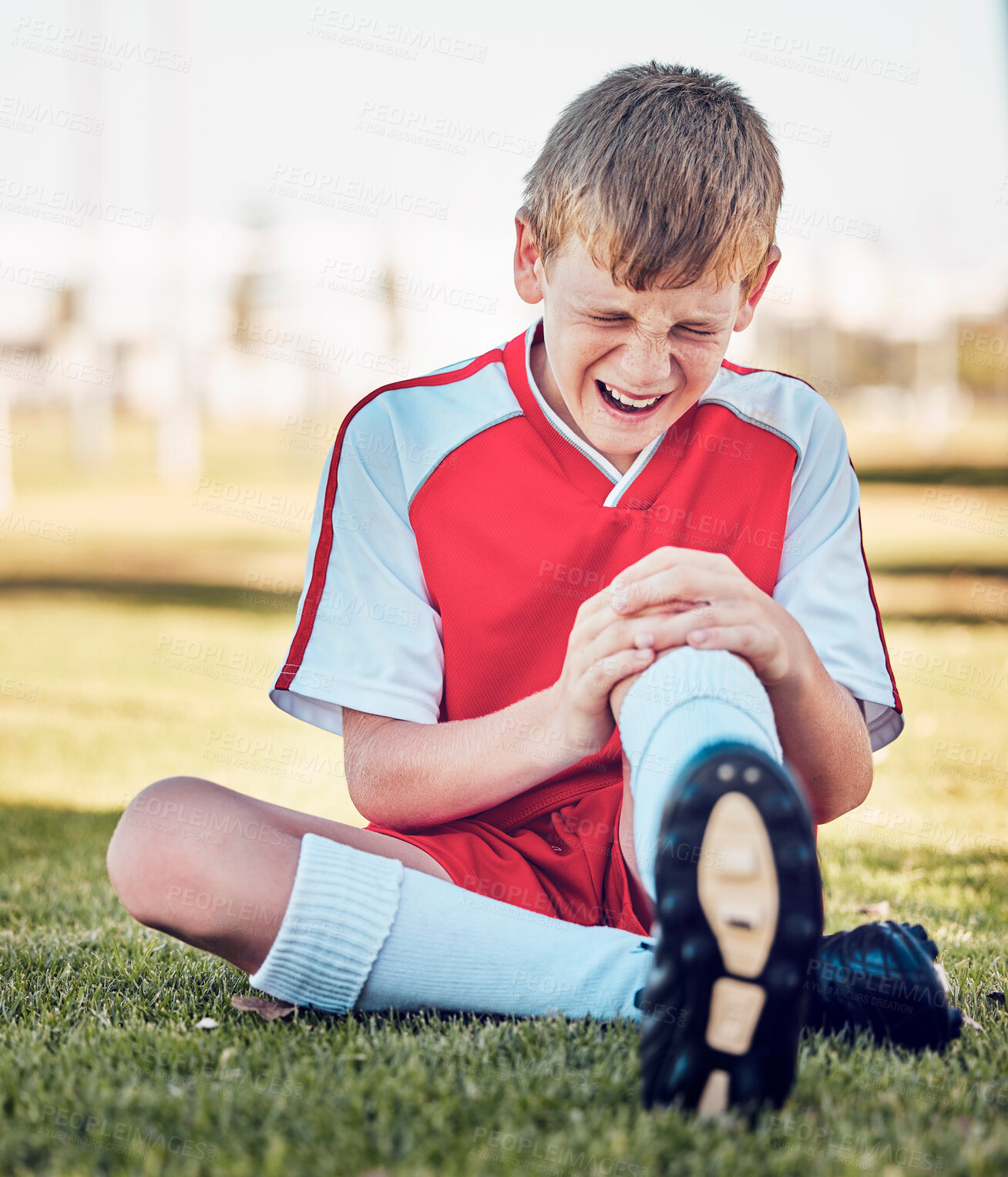 Buy stock photo Soccer, knee injury and pain on a field after match, training or fitness exercise at stadium pitch. Sports, football and boy in a medical emergency with torn muscle, sprain or broken bone in his leg.