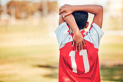 Buy stock photo Soccer, football and boy stretching arm getting ready for training, game or competition. Sports, back view or soccer player warm up on grass field preparing for practice, exercise or workout outdoors