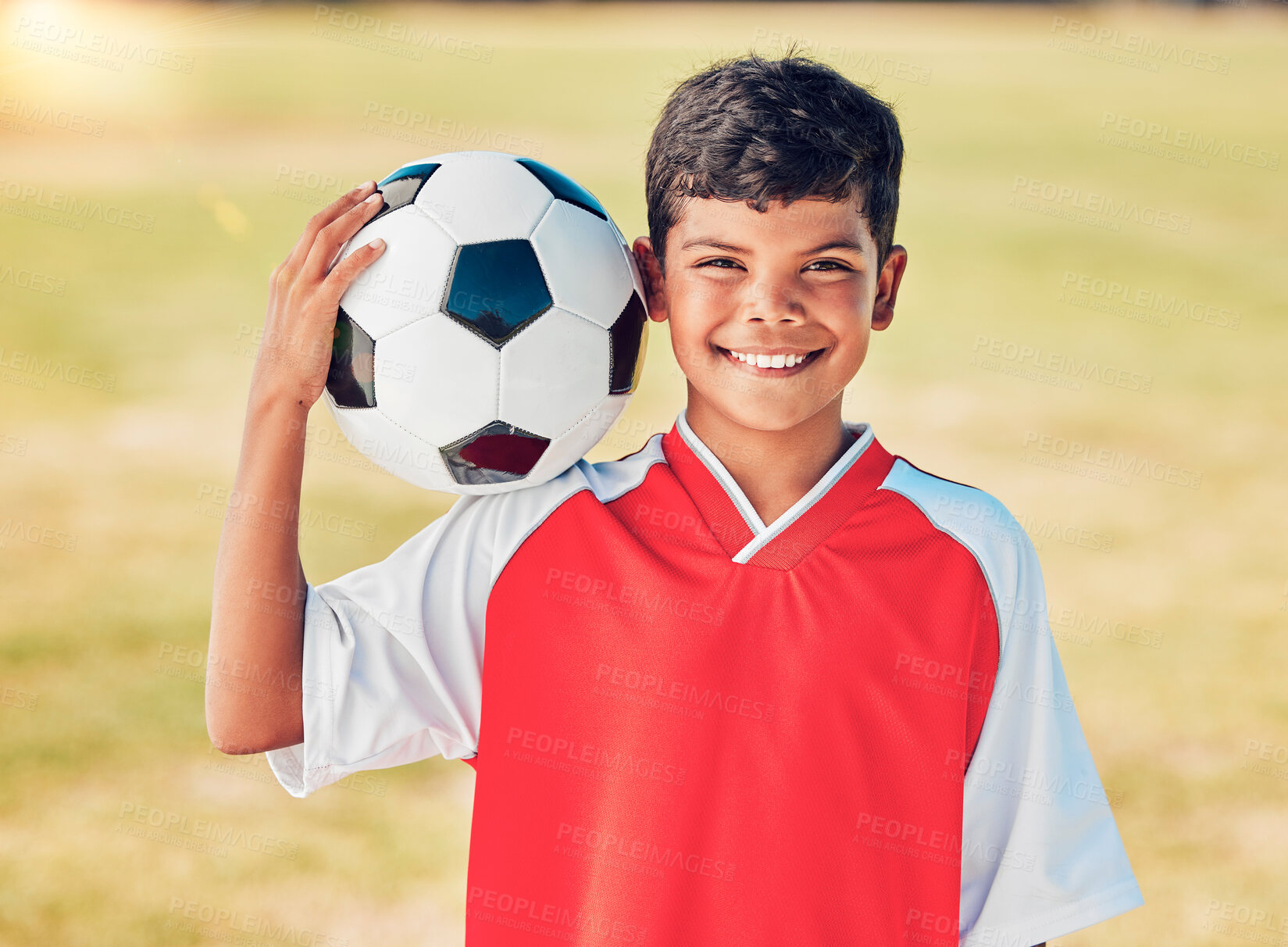 Buy stock photo Boy portrait, field and soccer ball with smile for sport, fitness or training at soccer game, contest or competition. Athlete kid, football and happy with ball on shoulder for sports outdoor on grass