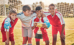Football, teamwork and sports with trophy and children at goal post for winner, happy and fitness. Exercise, success and award with soccer player celebration for workout, training and champion