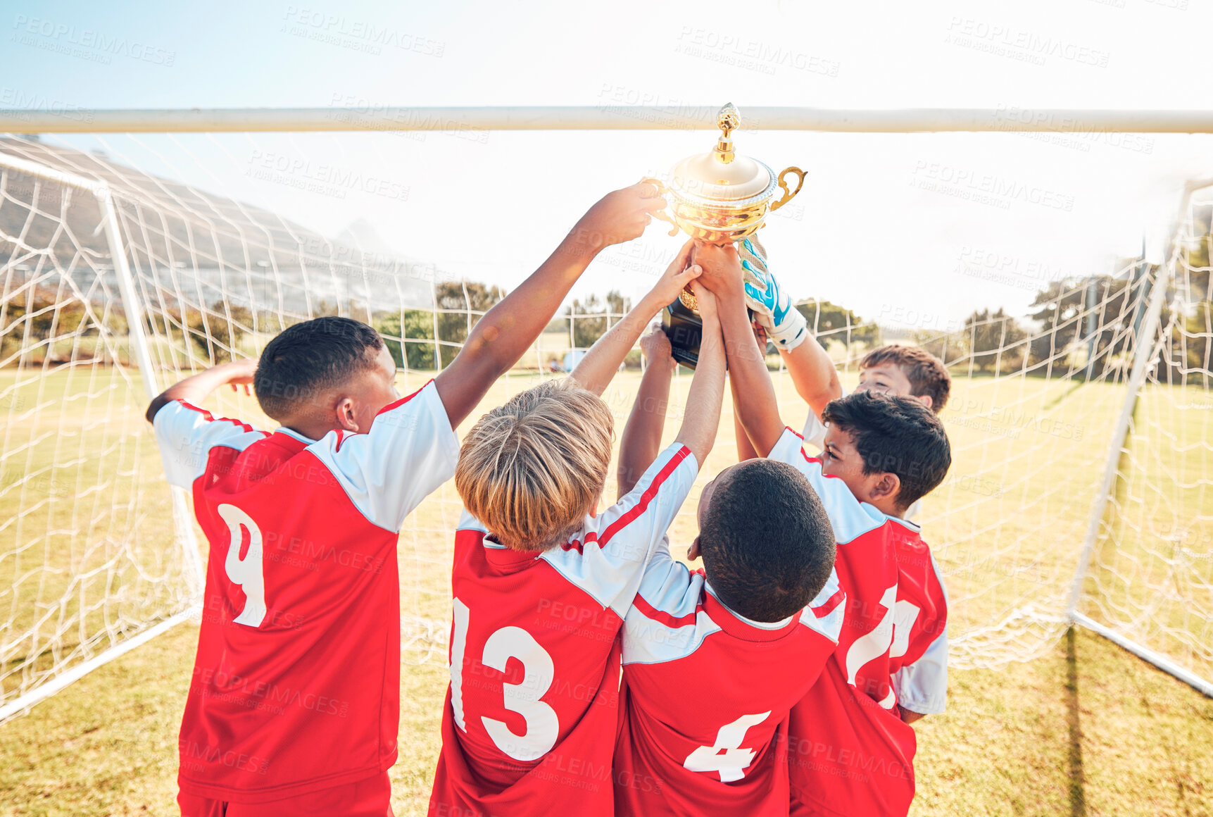 Buy stock photo Children, winner and team soccer with trophy celebrating victory, achievement or match on the field. Kids in celebration for teamwork, sports and football match or game win together in the outdoors