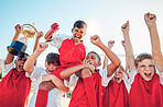 Soccer, winner team and sport trophy celebration in sunshine together after game, contest or competition. Happy, children and shouting for winning with boy kids, diversity and achievement in sports