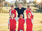 Soccer, children and portrait of a coach with his team on an outdoor field after a match or training. Football, sports and kids group standing with a trainer on a pitch for game, exercise or practice