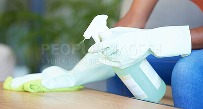 Buy stock photo Hands, table and cleaning during covid by woman sanitize, spray and bottle splash product closeup in a living room. Cleaning service, hand and cleaner doing household dust, hygiene and living space