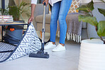 Cleaning, carpet and vacuum with black woman in living room for dust, furniture or housekeeping service. Electric, dirt and cleaner with shoes of housewife and floor at home for hygiene and lifestyle
