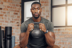 Fitness, gym and portrait of a black man with a kettlebell for strength training for wellness. Motivation, sports and strong African athlete doing a exercise or workout with weights at a health club 