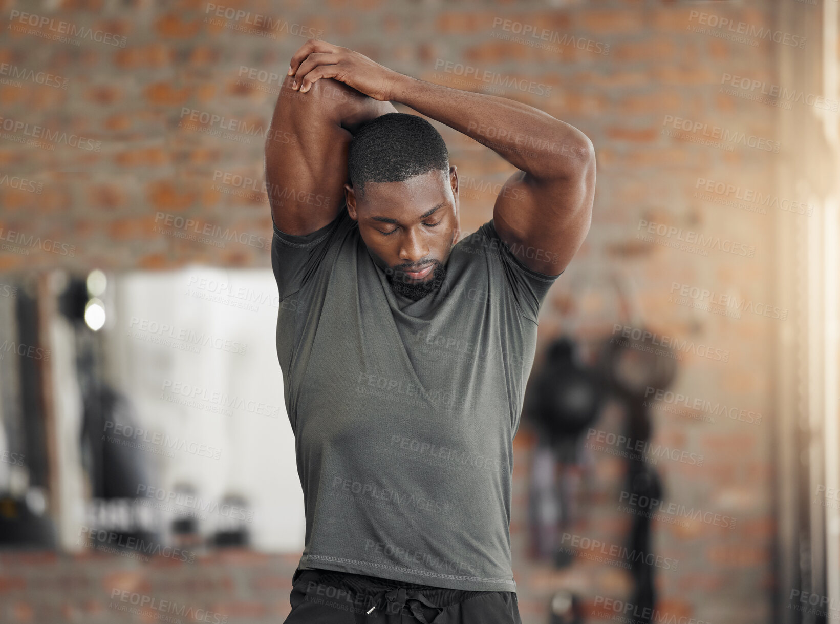 Buy stock photo Exercise, stretch and man at gym for training, health and wellness against a brick wall background mockup. Fitness, stretching and sport guy with relax mindset before workout,  cardio and performance