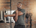 Black man, bodybuilder and stretching in gym for fitness, health and exercise in portrait with muscle. Man, strong and warm up for workout, training or performance for healthy body, wellness and life