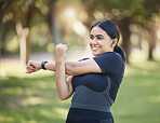 Fitness, nature and happy woman stretching in an outdoor park for health, wellness and training. Sports, healthy and girl athlete from Mexico doing a warm up exercise before a workout in green garden