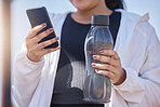 Exercise, phone and water for woman using fitness app to check progress, steps and health while outdoor for workout, running and training. Athlete runner with bottle and smartphone for social network