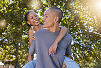 Love, tree leaf and couple hug while bonding, having fun and enjoy romantic quality time together in nature park date. Peace freedom, piggyback ride and happy black woman and gen z man play outdoor