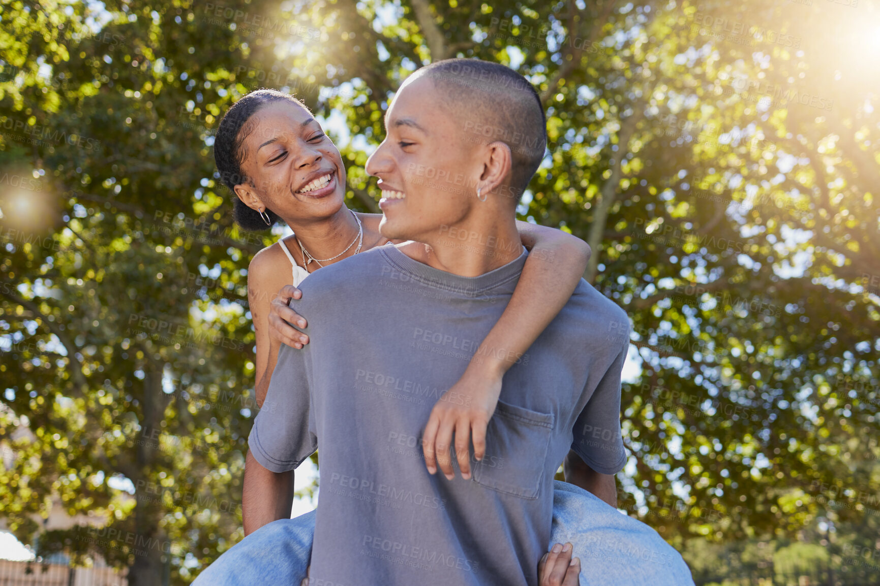 Buy stock photo Love, tree leaf and couple hug while bonding, having fun and enjoy romantic quality time together in nature park date. Peace freedom, piggyback ride and happy black woman and gen z man play outdoor