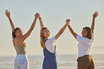 Happy, girl friends and beach travel with women on a holiday, freedom and travel holding hands. Portrait of people with arms raised to show excited adventure by the ocean and sea together by water