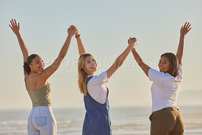 Buy stock photo Happy, girl friends and holding hands at a beach with women on a holiday, freedom and travel. Portrait of people with arms raised to show excited adventure by the ocean and sea together by water