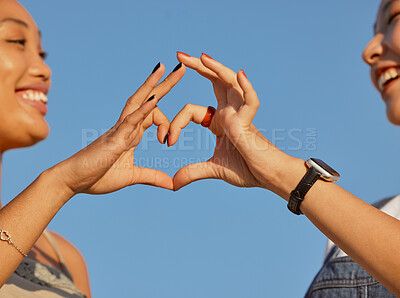 Buy stock photo Heart, love and friends with a sign of their support, trust and happy against a blue sky. Nature, care and women with emoji hands for travel natural environment and wellness in summer together
