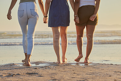 Buy stock photo Friends, girl group and back at beach for walk on vacation, holiday or summer travel together in sunshine. Legs, holding hands and women walking to relax in ocean sand, sea or water in solidarity