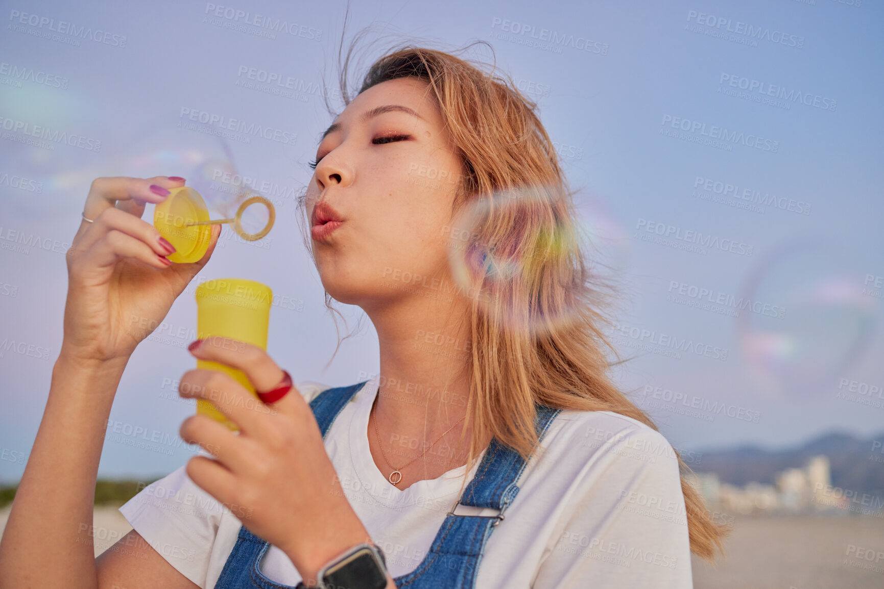 Buy stock photo Asian summer, woman with bubbles and blow liquid soap with lips in outdoor nature freedom with beauty face. Young girl playing with party toy, fun magic on beach mockup and blonde hair in Seoul wind