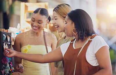 Buy stock photo Women, friends and shopping at outdoor market, happy with discount and sale with cosmetic jewellery. Diversity, friendship and young female shop together, retail therapy and earring choice.
