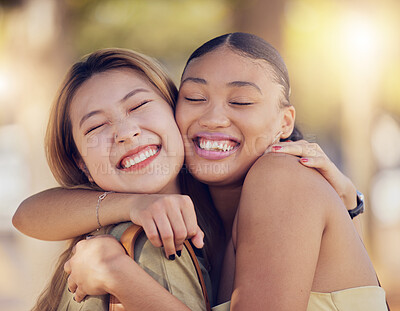 Buy stock photo Friends, women and hug for love, care and support while outdoor for travel, happiness and bonding with asian and black woman. Lesbian couple with a smile in nature for peace, summer and time together