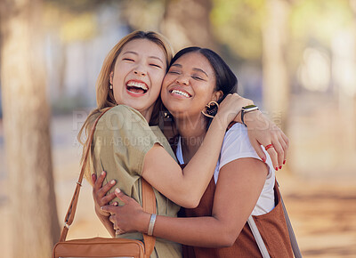 Buy stock photo Women, friends and happy hug in outdoor sunshine with embrace, love and smile in summer for vacation. Diversity, asian woman and black woman with happiness in nature, park and together in Jakarta