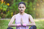 Woman, yoga and meditation for spiritual wellness, zen or calm exercise for the mind, body and health in nature. Female meditating in mindful awareness for healthy lifestyle and inner peace in a park