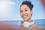 Woman, fitness selfie, happy at beach with smile for workout, exercise or training. Exercise, healthy or sports health influencer woman for wellness motivation for 5g social media post with headphone
