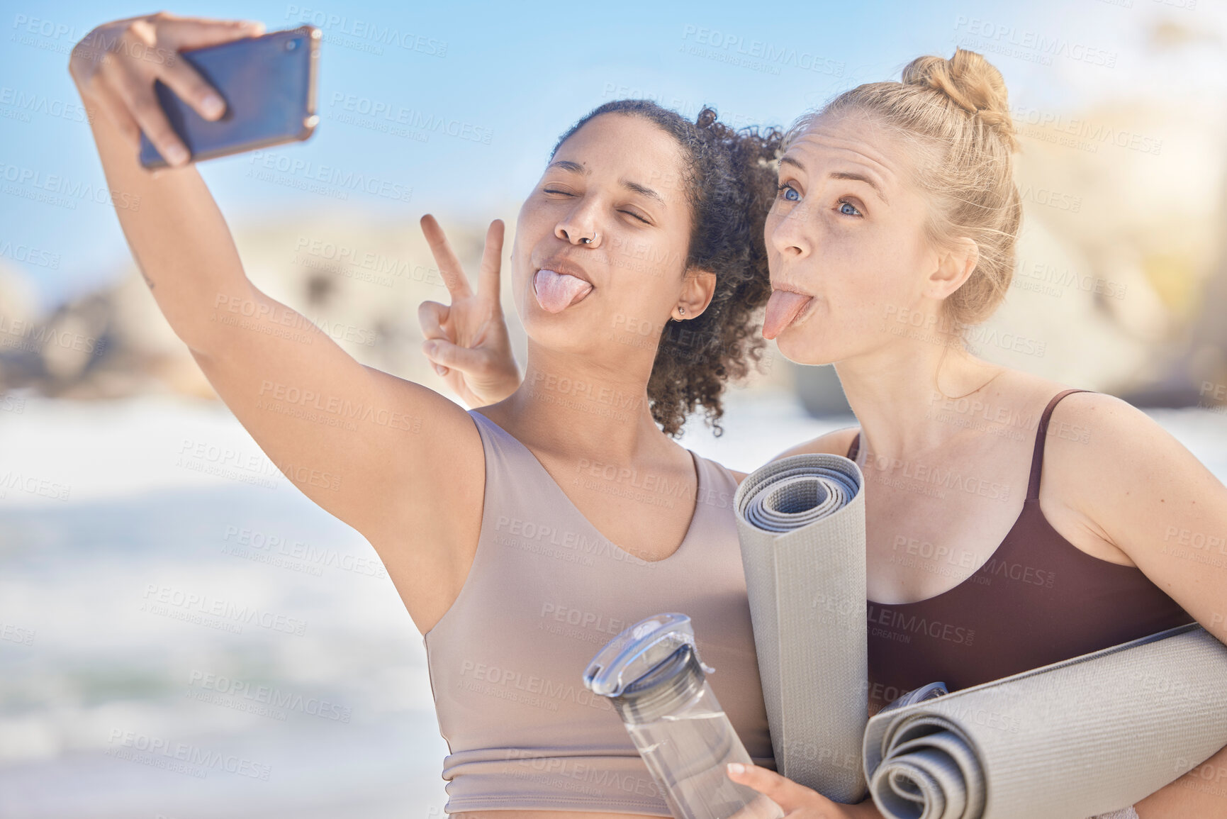 Buy stock photo Happy face selfie, yoga and women with yoga mat exercise at the beach for fitness workout, spiritual health and zen meditation. Fun with a friend, stress relief and pilates wellbeing workout training
