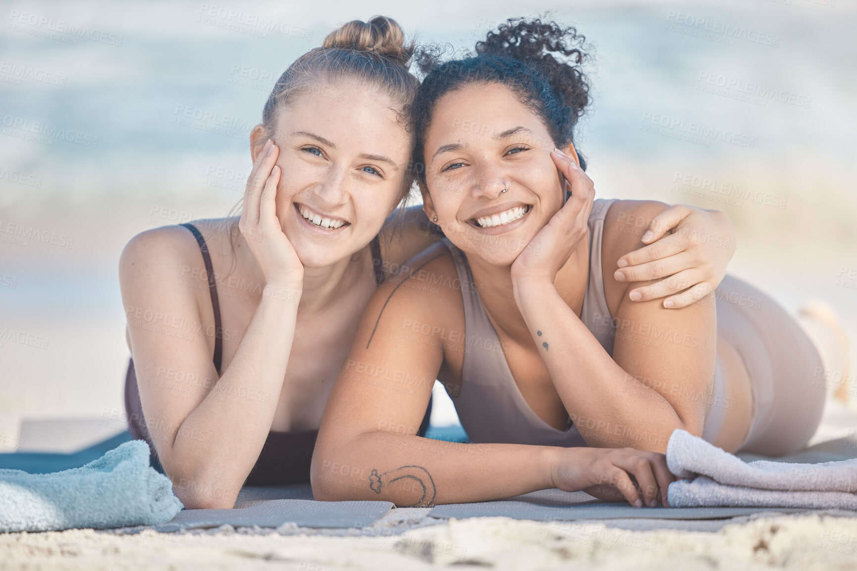 Buy stock photo Friends, beach and diversity with a black woman and happy friend lying on the sand by the sea or ocean in nature. Face, smile and summer with a female and friend by the water to relax on vacation
