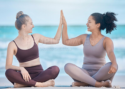 Buy stock photo Woman, friends and high five in yoga at the beach for spiritual training or wellness exercise on the sand. Happy women relaxing touching hands in success for healthy zen or lifestyle balance together