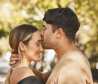 Buy stock photo Kiss, love and romance with a couple bonding outdoor during a date on a summer day. Happy, trust and smile with a young man and woman kissing outside together while dating or being romantic