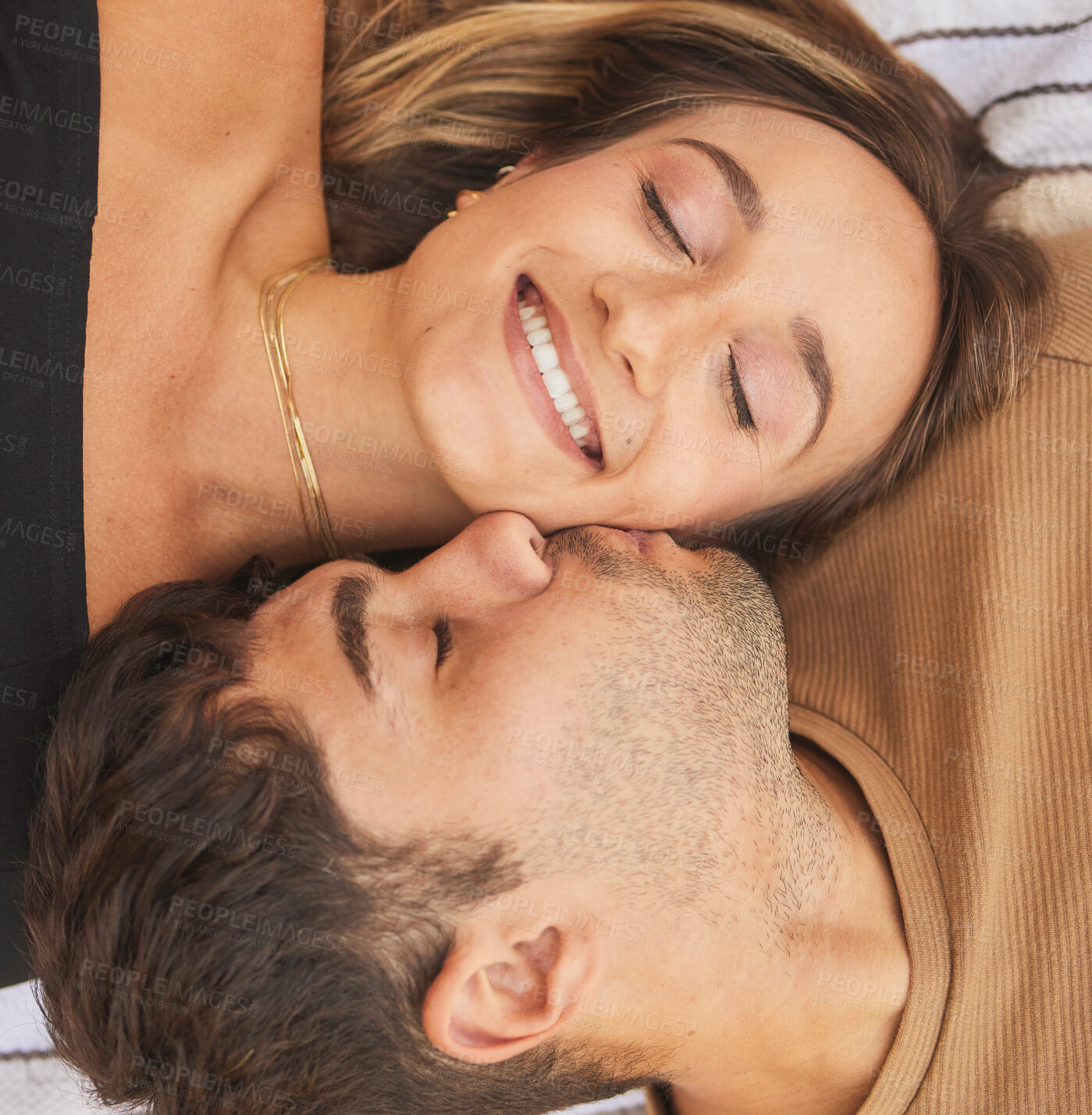 Buy stock photo Couple, kiss and smile with love and care in romantic overhead, happy together and bonding for healthy relationship. Man, woman and happiness, face and eyes closed with romance and quality time.