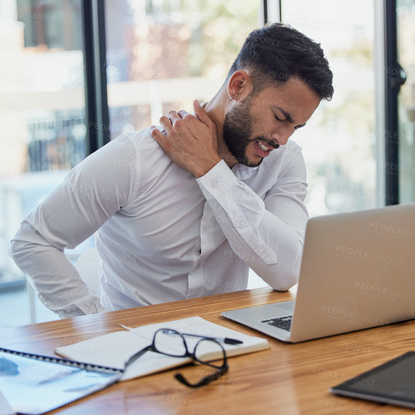 Buy stock photo Man, shoulder pain and laptop while working in office suffering from stress, depression and burnout at desk. Arab businessman sitting to massage body feeling tired and fatigue