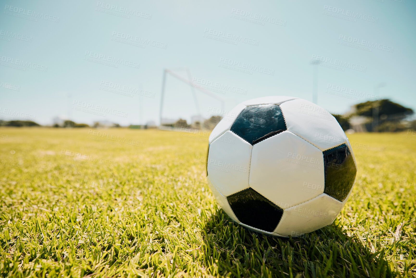 Buy stock photo Soccer, sports and fitness with a ball on a grass pitch or field ready to a game or match outdoor during summer. Football, soccer ball and mockup with sport equipment at an outside competition venue