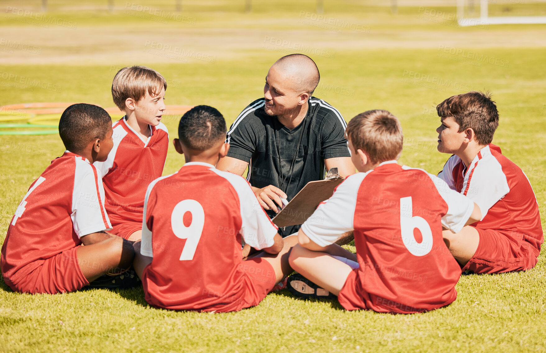 Buy stock photo kids, soccer and team coach planning training with clipboard on soccer field for sport competitiion together. Athlete children, teamwork and sit on grass before football match or workout outdoors