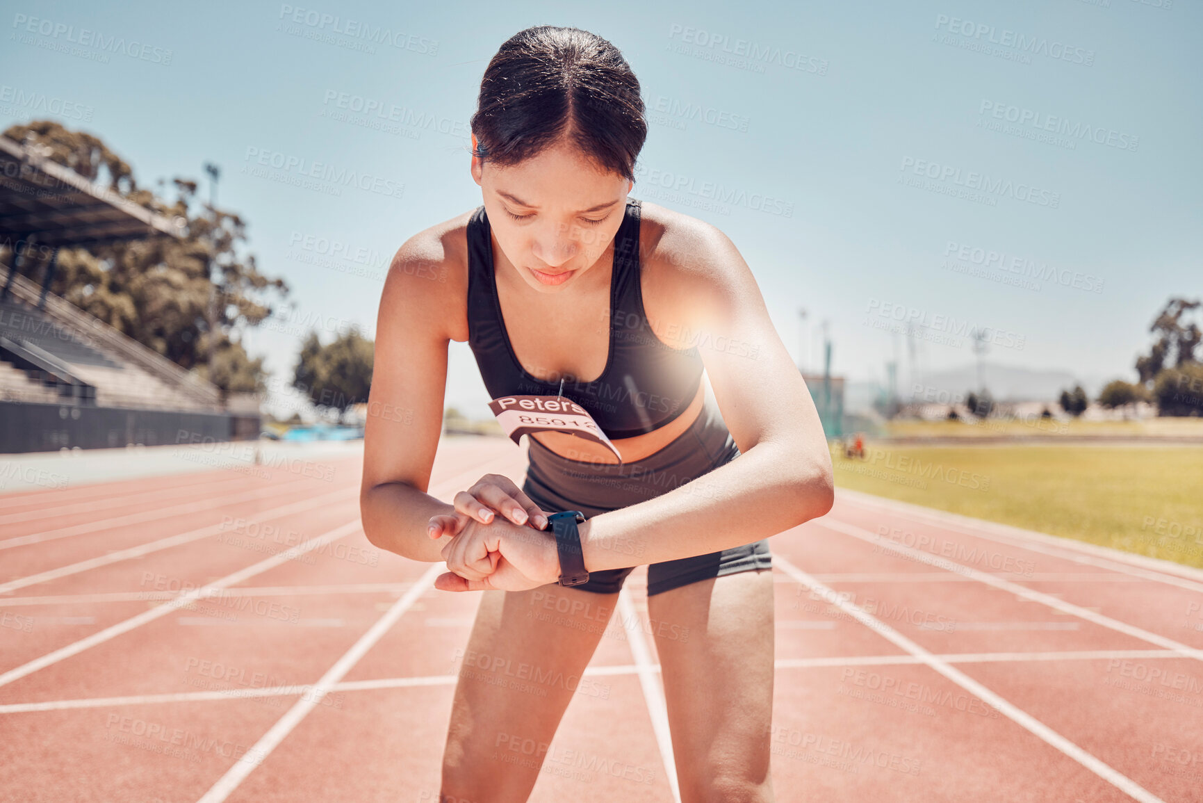 Buy stock photo Smartwatch, sports and woman check time, workout goal or progress during training, running or exercise at stadium in summer. Runner, athlete or fitness girl with smart watch or workout technology app