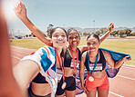 Selfie, medal and friends with a British flag after running, fitness and sports at a stadium. Collaboration, winning and women athlete group with a photo after achievement in sport or marathon