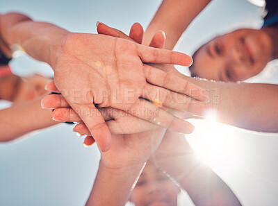 Buy stock photo Group, team and hands stack below for girl, friends and happy in sunshine, collaboration and motivation. Hand, together and teamwork for goal, success or support in solidarity, diversity and blue sky