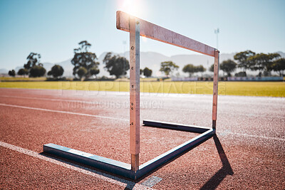 Buy stock photo Empty stadium, field and running hurdle or barrier at outdoors race track. Sports, athletics or jumping obstacle, metal equipment for runners or athletes for competition, exercise or training outside