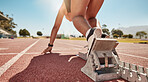 Woman, runner and start for running, training and exercise for sports, event or race on a track. Young female sport athlete ready in workout challenge, speed and marathon for endurance and fitness
