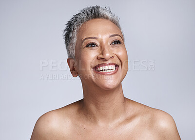 Buy stock photo Cosmetics, senior woman and thinking with skincare for wellness, health and natural beauty with grey studio background. Confident, mature lady and elderly female with smile, makeup and smooth skin.