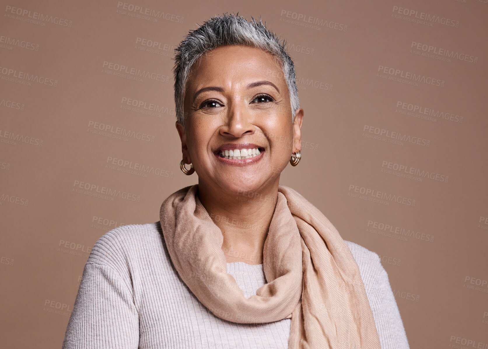 Buy stock photo Face, fashion and beauty with a senior woman in studio on a brown background to promote contemporary style. Portait, fashionable and trendy with a mature female posing to model a clothes brand