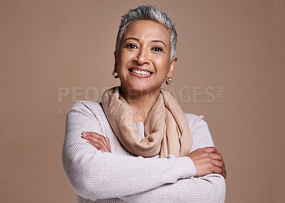 Buy stock photo Face, fashion and style with a senior woman in studio on a brown background to model contemporary clothes. Portrait,  fashionable and stylish with a mature female posing to promote a clothing brand