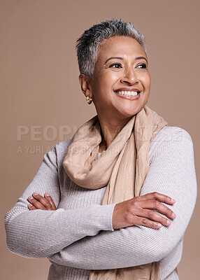 Buy stock photo Fashion, thinking and style with a senior woman in studio on a brown background to model a contemporary brand. Idea, smile and trendy with a mature female posing to promote clothing or clothes