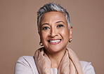 Face, fashion and senior woman in studio isolated against a brown background. Beauty portrait, smile and makeup cosmetics or aesthetics of happy elderly model from India in designer scarf or clothes.