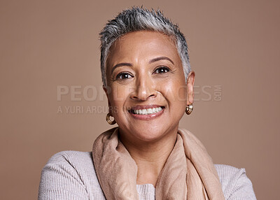 Buy stock photo Face, fashion and senior woman in studio isolated against a brown background. Beauty portrait, smile and makeup cosmetics or aesthetics of happy elderly model from India in designer scarf or clothes.