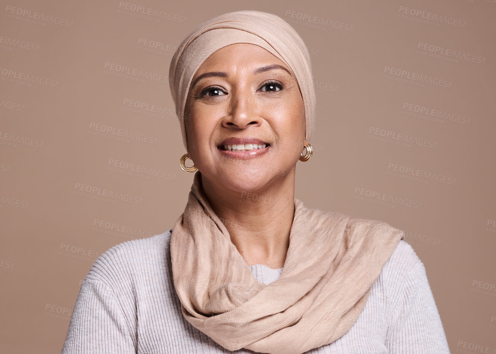 Buy stock photo Muslim, hijab and arab ,woman in studio for beauty, religion and happiness for cosmetics, makeup and fashion on a brown background. Face portrait of a female with a smile for skincare with a glow