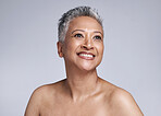 Senior model, beauty and smile on face for makeup, cosmetics and skincare with vision in studio. Elderly black woman, cosmetic wellness and happy for skin glow, shine and health by grey background