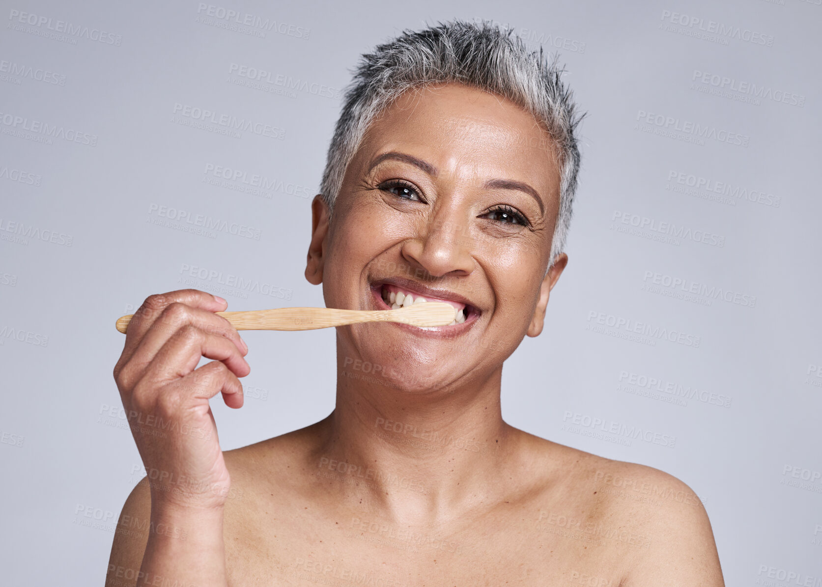 Buy stock photo Mature woman, toothbrush and brushing teeth on studio background, morning grooming routine or healthcare wellness. Portrait, smile or beauty model in dental care cleaning or happy hygiene maintenance