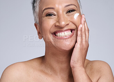 Buy stock photo Senior woman, sunscreen and face in studio, skincare cream product for natural uv protection or cosmetic wellness. Advertising beauty facial, happy elderly model with smile or dermatology spf lotion